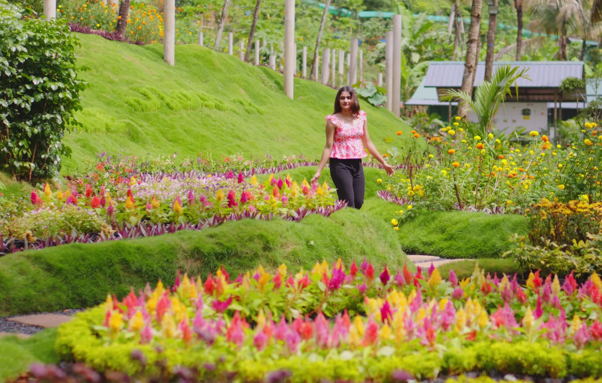 A visitor walking through the gardens at Able Village